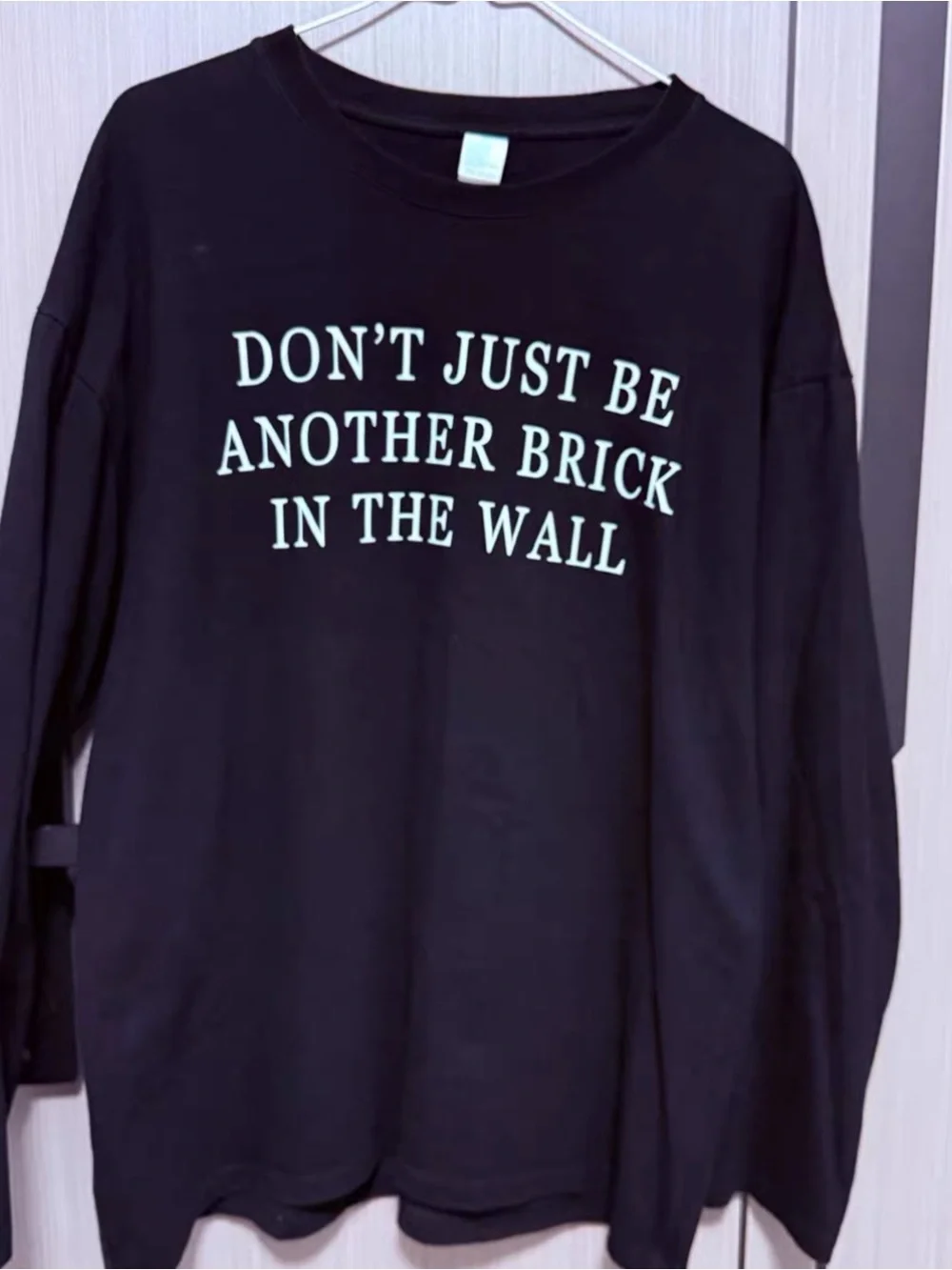 DON'T JUST BE ANOTHER BRICK IN THE WALL Black Wall Art Print